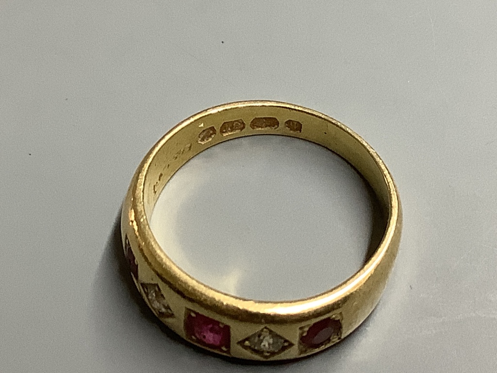 A late Victorian 18ct gold and gypsy set three stone ruby and two stone diamond half hoop ring